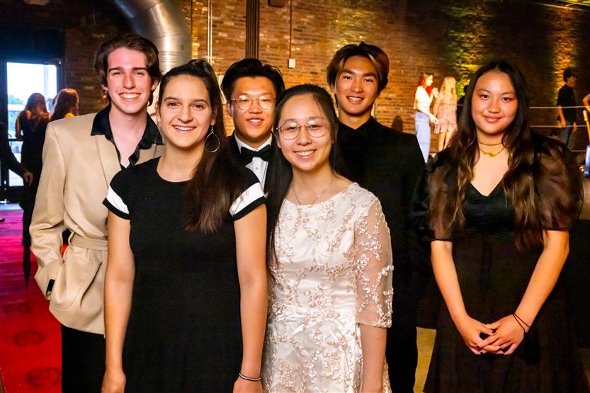 A group of students smiles